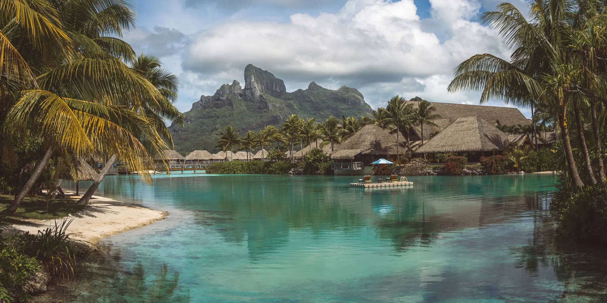 French Polynesia – diving with sharks lagoon with bamboo huts