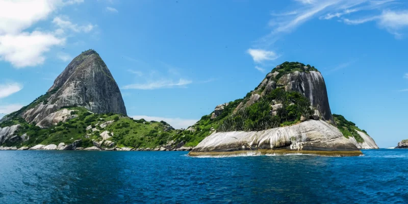 Rocky, green islands of the Alcatrazes archipelago in the blue Atlantic Ocean