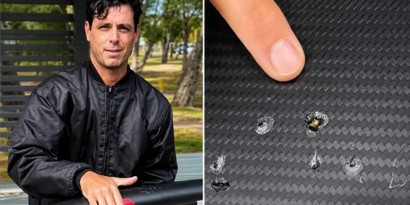 Dave Seymour shows shark tooth marks on his damaged e-foil board