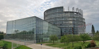 European Parliament building in Strasbourg with glass façades and flags