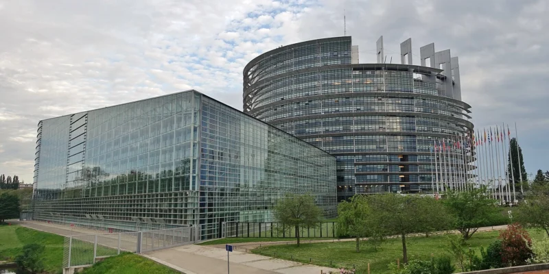European Parliament building in Strasbourg with glass façades and flags