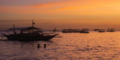 Fishing boats at sea at sunset off Bohol, Philippines