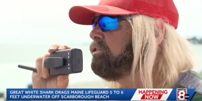 Lifeguard Greg Wilfert speaking into a radio at Scarborough Beach