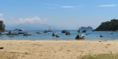 Beach view on Ilha Grande with boats and a cruise ship