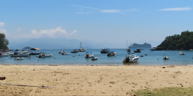 Beach view on Ilha Grande with boats and a cruise ship