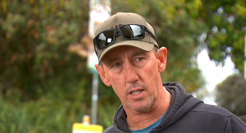 Surfer Matthew Devine wearing a cap and sunglasses on its brim during an interview