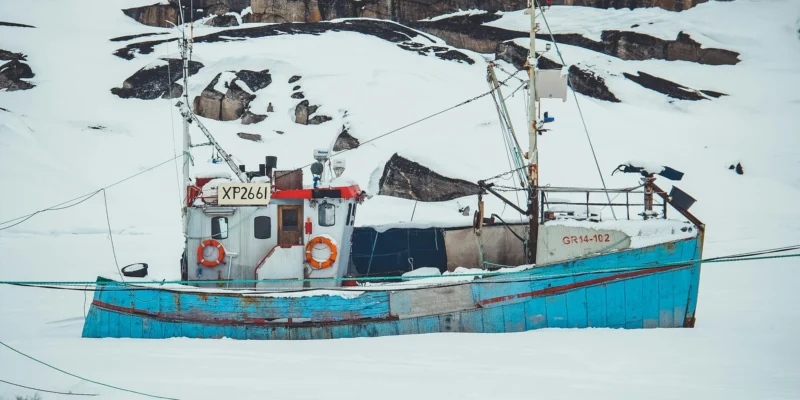 Fishing boat in a snow-covered polar landscape