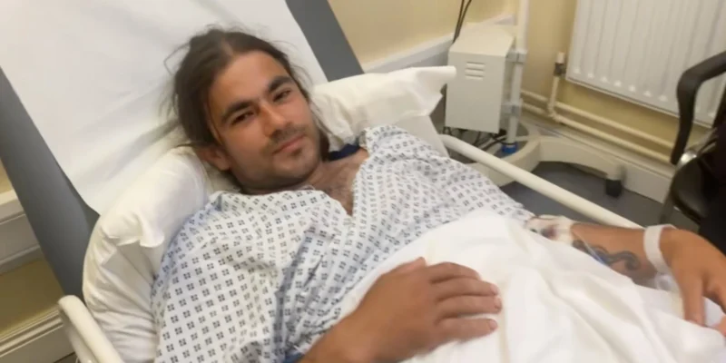 Sebastian Achim lying in a hospital bed after the blue-shark bite